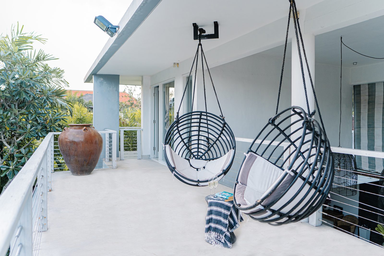 Hanging swing chairs on the terrace at CassaMia Bali villa